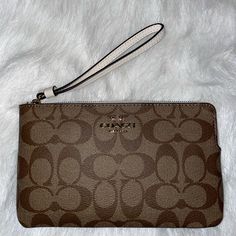 Nwt Coach Large Corner Zip Wristlet In Signature Canvas. Signature Coated Canvas And Smooth Leather Two Credit Card Slots Zip Closure, Fabric Lining Wrist Strap Attached 7 3/4" (L) X 4 3/4" (H) X 1/2" (W) Elegant Beige Clutch With Wrist Strap, Elegant Brown Wristlet For Evening, Elegant Coach Wristlet As Gift, Coach Pouch Wristlet For Formal Occasions, Classic Coach Wristlet For Formal Occasions, Elegant Coach Wristlet Perfect For Gifts, Elegant Brown Evening Wristlet, Elegant Coach Pouch Wristlet, Elegant Brown Clutch With Wrist Strap