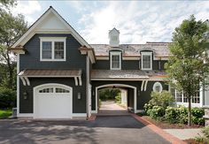 a large house with two garages and an attached driveway