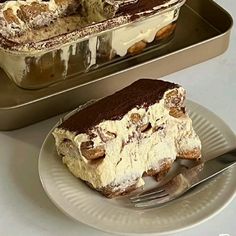 a piece of cake sitting on top of a white plate next to a silver pan