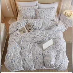 a bed with blue and white flowers on it