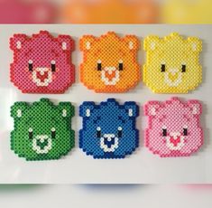 four different colored bears made out of perler beads