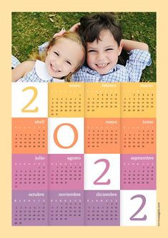 two children laying on top of each other in front of a calendar