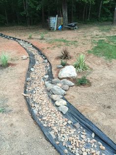 a garden with rocks and gravel on the ground