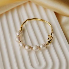 This stunning Freshwater Pearl & Gold Plated Bracelet features lustrous freshwater pearls, each separated by delicate gold beads, strung on a beautifully textured gold-plated band. With a secure and easy-to-use clasp for effortless wear, this piece is a must-have accessory for any occasion. 💖Please be aware that natural pearls may exhibit variations in shape and minor surface irregularities, serving as evidence of their organic origin. ✨Specifications: - Length: 17cm - 18cm (Customization is av Elegant Bridal Jewelry, Pearl Bangle, Gold Plated Bracelets, Jewelry Wedding, Bracelet For Women, Gold Texture, Baroque Pearls, Natural Pearls, Gold Beads