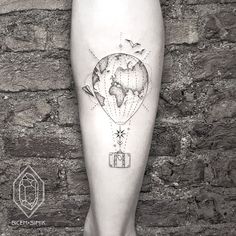 a tattoo on the leg of a person with a hot air balloon flying over it