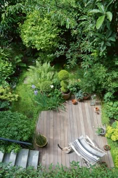 an aerial view of a wooden deck surrounded by greenery