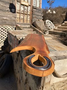 a wooden object sitting on top of a pile of wood