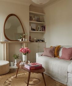 a living room filled with furniture and a mirror