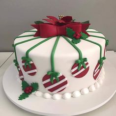 a white cake with red and green decorations