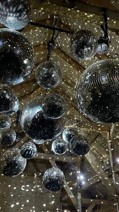 disco balls hanging from the ceiling in a barn