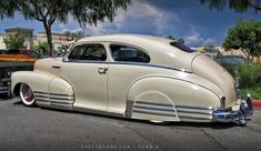 an antique car is parked on the side of the road