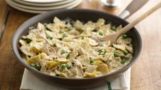 a skillet filled with pasta and peas