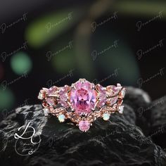 a pink ring sitting on top of a rock