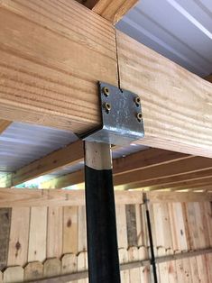 a close up of a metal beam on a wooden structure