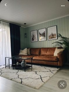 a living room filled with furniture and pictures on the wall