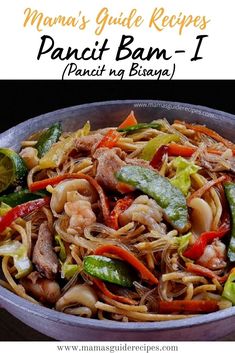 a pan filled with noodles and vegetables on top of a table