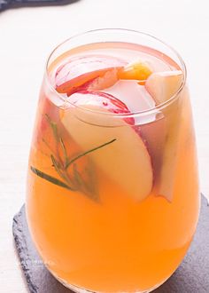 a glass filled with liquid sitting on top of a table