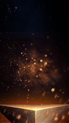 fireworks in the night sky over a golden pyramid with stars and dust flying around it