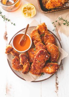 some fried food on a plate with dipping sauce