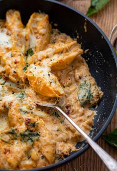 a skillet filled with chicken and cheese