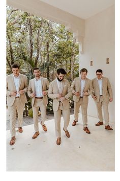 a group of men in suits standing next to each other on a white tiled floor