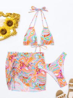 Embrace your inner mermaid with our Melusine bikini set. Featuring a playful swirl print and ruched tie detailing, this three piece set includes a halter strap for a secure fit. Made with comfortable polyester, you'll be ready to make a splash all summer long. Specs: Material: Polyester Drawstring Swimwear For Beach Season Party, Multicolor Swimwear With Drawstring For Sunbathing, Multicolor Drawstring Swimwear For Sunbathing, Multicolor Stretch Swimwear With Drawstring, Halter Neck Swimwear With Drawstring For Beach Party, Multicolor Drawstring Swimwear For Beach Party, Multicolor Drawstring Swimwear For The Beach, Halter Neck Beachwear Swimwear With Drawstring, Halter Neck Swimwear With Drawstring