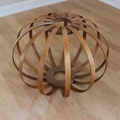 a wooden sculpture sitting on top of a hard wood floor