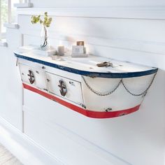 a boat shaped shelf is hanging on the wall