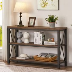 a shelf with books and pictures on it in a living room next to a window