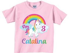 "3rd Birthday shirts with adorable unicorn and rainbow. The front shows a picture of a unicorn with a rainbow that says \"I'm 3\" along with the child's name. ** This can be made for any age not just 3.** As shown in the listing the name can only be multicolored on the white, pink and, black shirts. The name will be white on the turquoise and red shirts because the multi -color combination does not show up well on those shirt colors. Please note that the shade of the shirt colors will differ fro Rainbow Short Sleeve Top For Birthday, Rainbow Short Sleeve Top For Birthdays, Fun Unicorn Print Top For Birthday, Fun Unicorn Print Tops For Birthday, Cotton Unicorn Print Top For Birthday, Cute Unicorn Print Birthday T-shirt, Pink Unicorn Print T-shirt For Birthday, Birthday Unicorn Print Crew Neck T-shirt, Affordable Unicorn Print T-shirt For Birthday