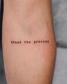 a tattoo saying trust the process on someone's leg