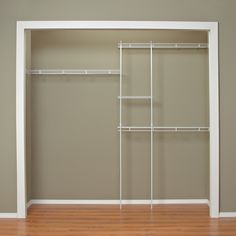 an empty closet with shelving unit and hard wood flooring in the middle of it