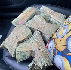 bundles of money sitting in the back seat of a car