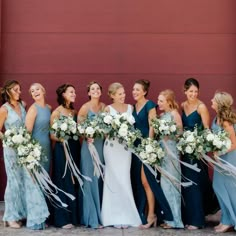 a group of women standing next to each other with bouquets in front of them