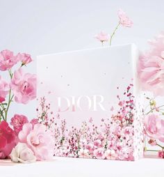 a box with pink flowers on it and the word dior in front of it