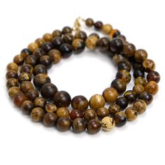 two strands of tiger's eye beads on a white background