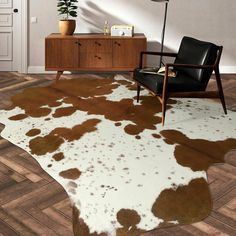 a living room with a cowhide rug on the floor and a chair in front of it