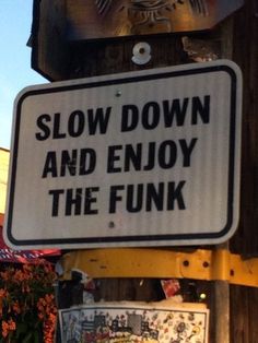 a sign that says slow down and enjoy the funky