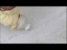 a person standing next to a white cup on the ground with their feet in it