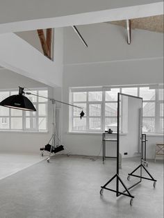 an empty room with multiple lights and chairs