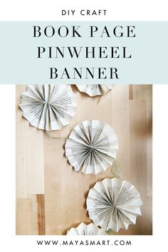 three paper fans on top of a wooden floor with text overlay that reads, book page pinwheel banner