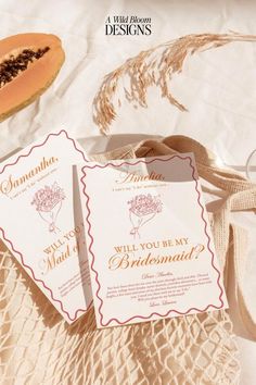 wedding stationery with watermelon and bridesmaid tags on it, sitting on a bed