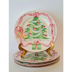 a set of three plates decorated with christmas trees and bows on each plate is the centerpiece