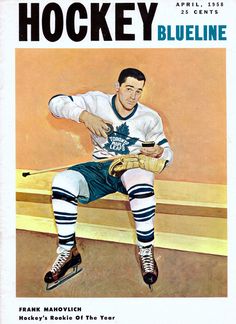 the hockey player is sitting down with his mitt in one hand and holding a cup