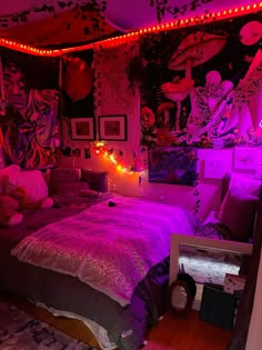 a bedroom decorated in pink and purple lights