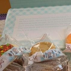 two bags of cookies sitting next to each other on top of a table in front of a note