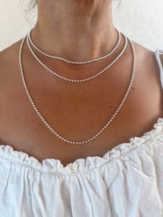 925 silver ball chain. Sterling silver pearl chain. Silver ball chain. 2 ball diameters are available: 1.5 mm and 2.5 mm 3 lengths: 40 cm - 45 cm and 60 cm Our chains are made in Italy with CEE standards. Which guarantees a quality, nickel-free product. They are hallmarked 925. They are ideal for your pendants and your creations. And perfect as a simple necklace or to layer with different lengths and diameters of pearls. ------Description--------- With the 2.5 cm beads the clasp is lobster type. Silver Jewelry With Ball Chain And Round Beads, Silver Jewelry With Round Beads And Ball Chain, Silver Chain Necklace With Polished Round Beads, Silver Chain Necklace With Round Beads, Silver Necklace With Satellite Chain And Round Beads, Dainty Silver Chain Necklace With Round Beads, Minimalist Silver Ball Chain Jewelry, Silver Beaded Chain Necklace With Round Beads, Minimalist Silver Jewelry With Ball Chain