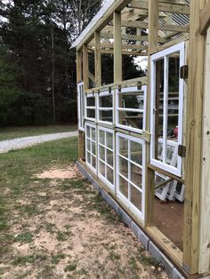 a small wooden structure with windows on the side