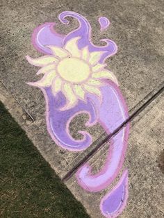 the sidewalk is painted with purple and yellow designs on it, as if in an artistic manner