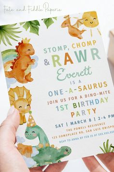 someone holding up a birthday card with dinosaurs on it